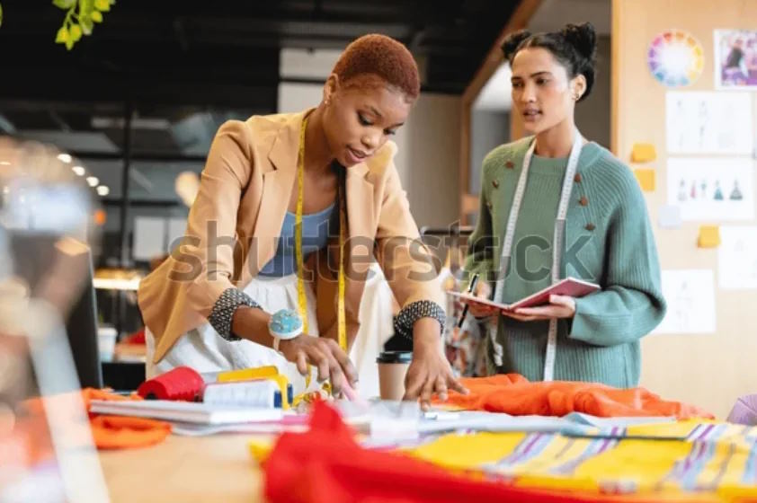 Fashion 1 Screenshot 2023-11-14 at 09-57-45 Multiracial Young Female Fashion Designers Discussing Stock Photo 2180203927 Shutterstock